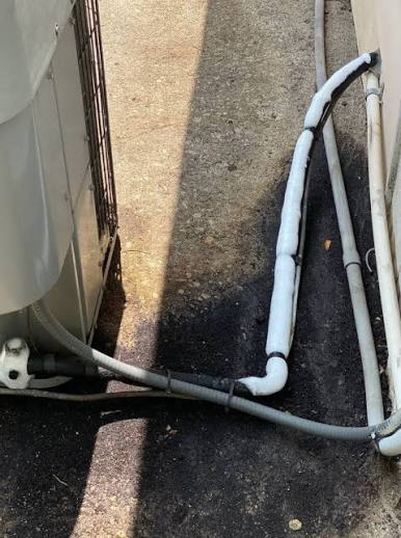 Frozen AC suction line showing a low refrigerant or airflow problem symptom